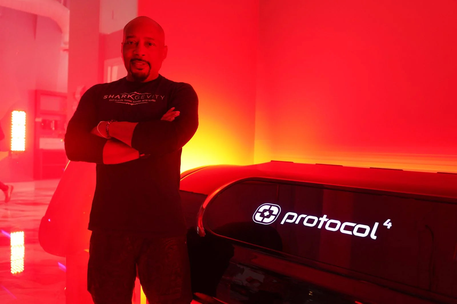 Daymond John with Protocol⁴ technology in a red-light wellness space
